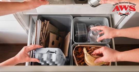 hands placing items in recycling bin