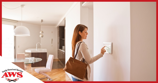 Woman changing thermostat