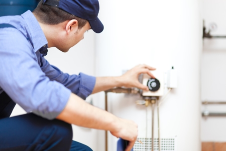 Man inspecting a water heater