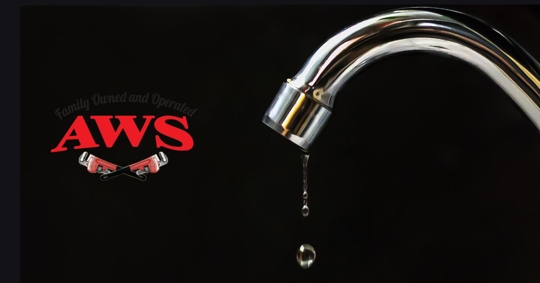 faucet dripping on black background